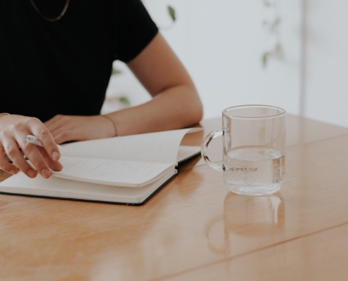 Frau schreibt am Tisch